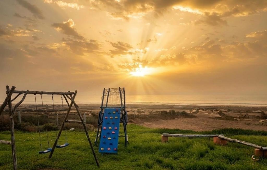 Tazgha House sunset garden with ocean view